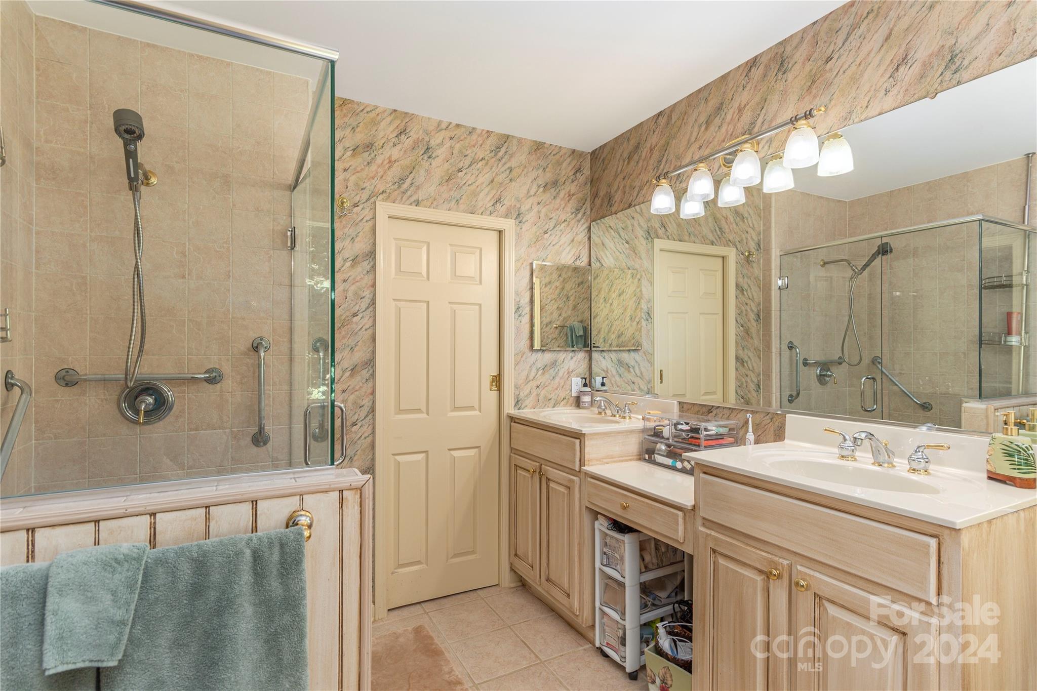 3191 Pigeon Road Waynesville, NC 28786 - Photo 20 of 33 a bathroom with a double vanity sink mirror and shower