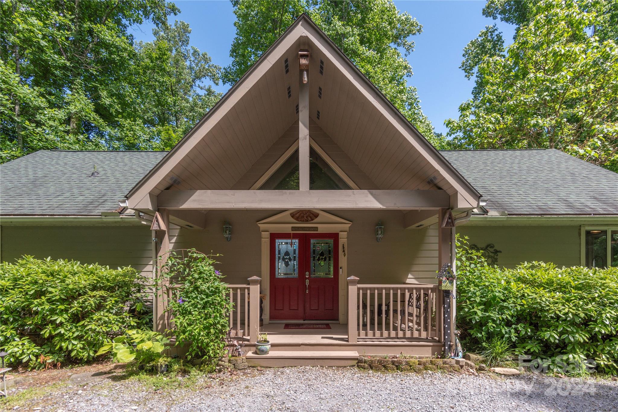 3191 Pigeon Road Waynesville, NC 28786 - Photo 2 of 33 a view of a house with a small yard plants and large tree