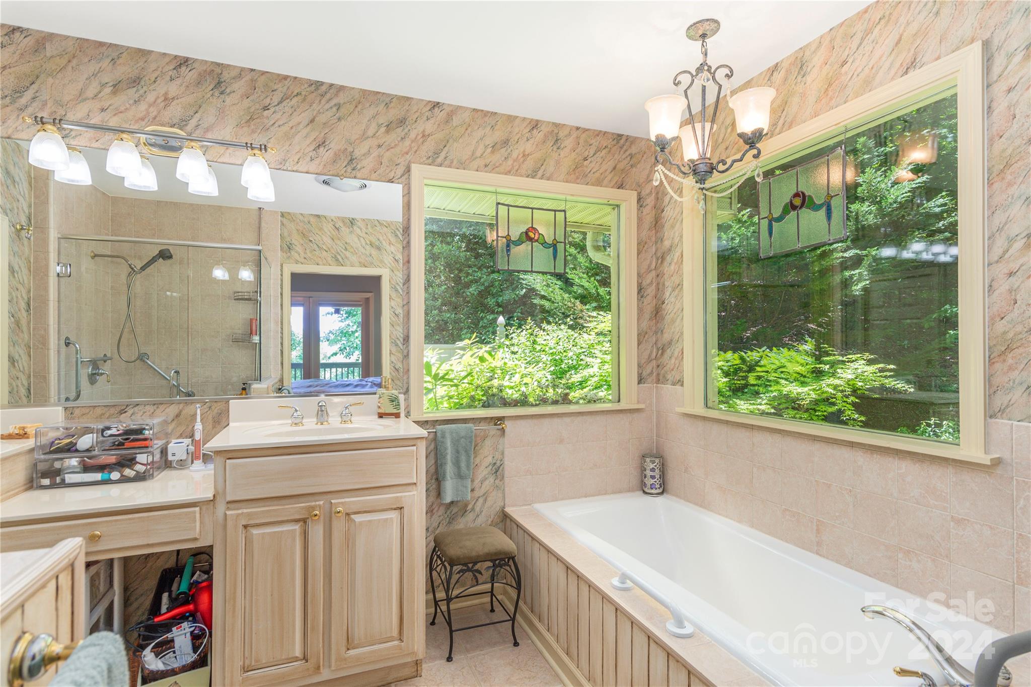 3191 Pigeon Road Waynesville, NC 28786 - Photo 21 of 33 a bathroom with a granite countertop sink a large mirror and a bathtub next to a window