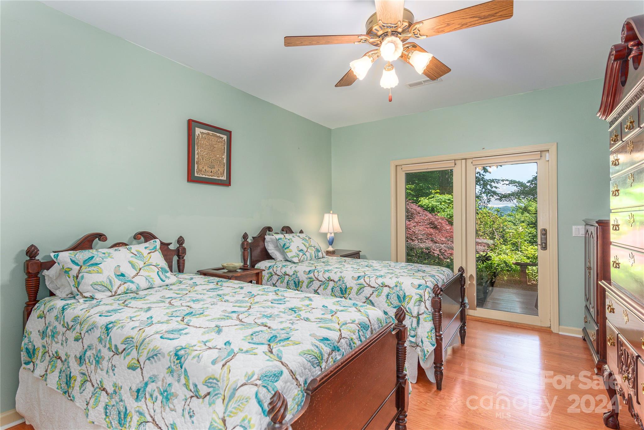 3191 Pigeon Road Waynesville, NC 28786 - Photo 24 of 33 a bedroom with a bed and a chandelier