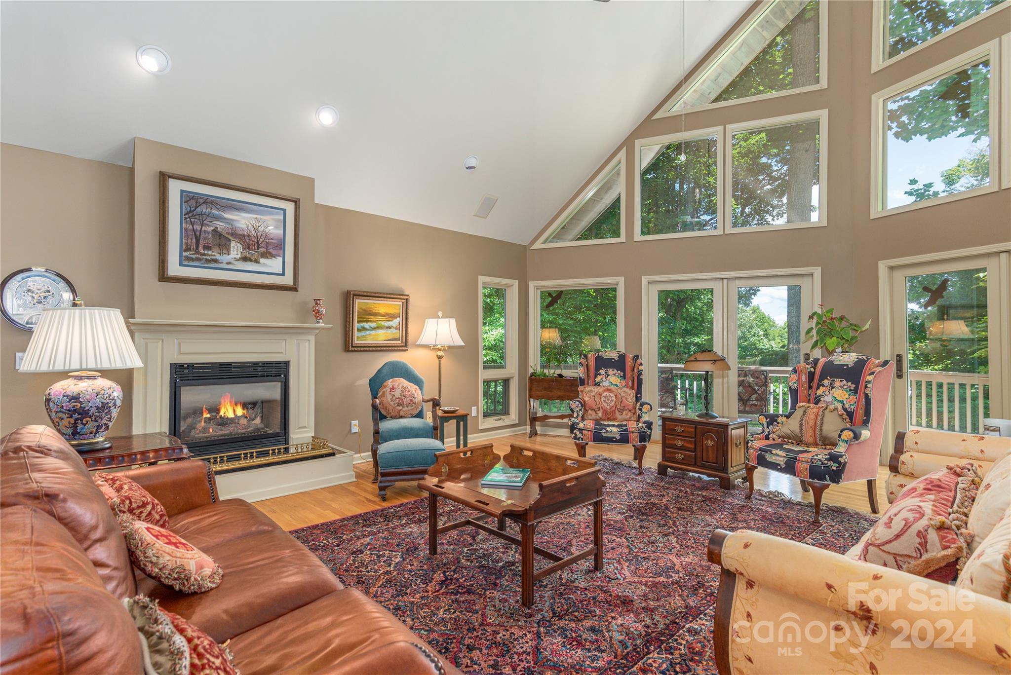 3191 Pigeon Road Waynesville, NC 28786 - Photo 4 of 33 a living room with furniture a fireplace and a large window