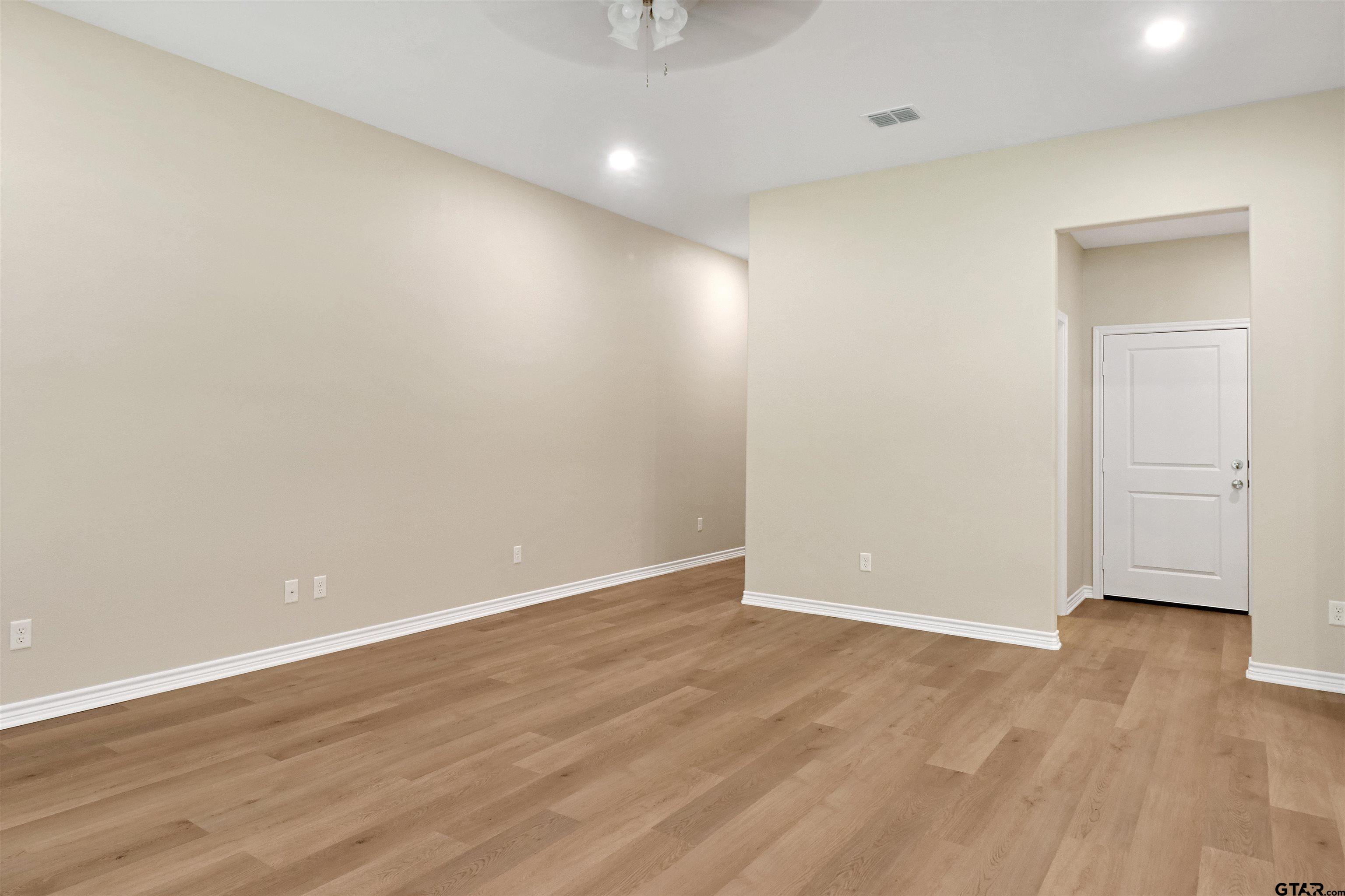 3053 Guinn Farms Road Tyler, TX 75707 - Photo 6 of 32 a view of an empty room with wooden floor