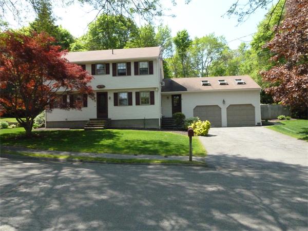 a view of a house with a yard and a fountain