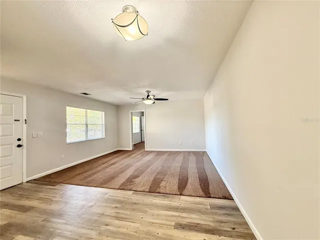 wooden floor in an empty room with a window