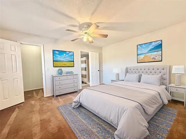 a spacious bedroom with a bed and a cabinets