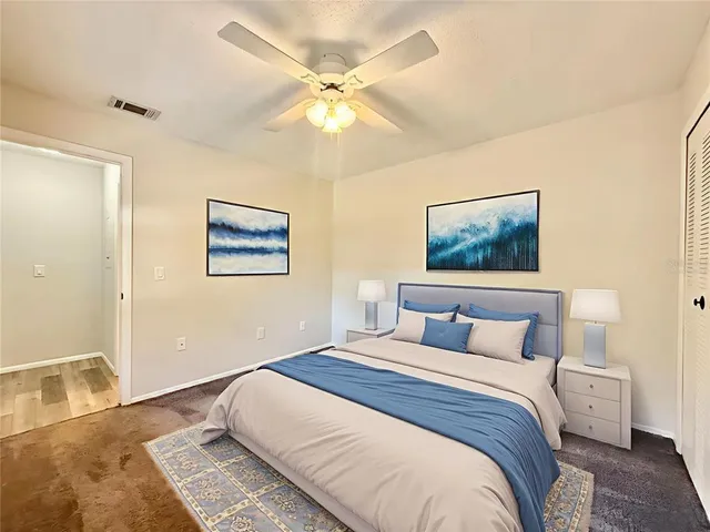a bedroom with a large bed and a chandelier