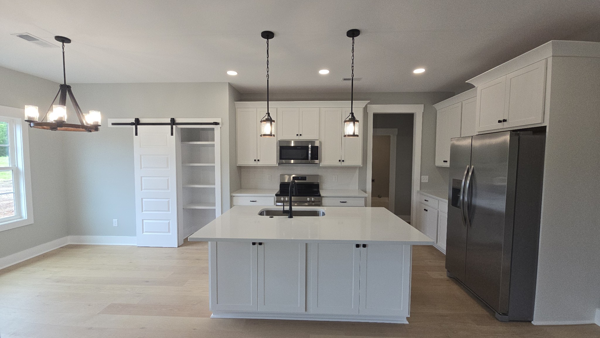 11533 Karo Road Bell Buckle, TN 37020 - Photo 4 of 22 a kitchen with kitchen island a counter top space stainless steel appliances and a chandelier