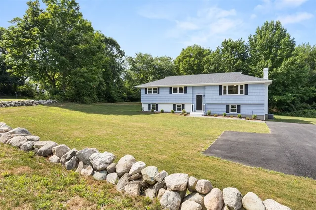 a view of a house with swimming pool and a yard