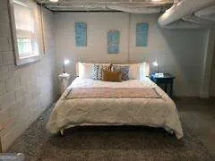 a bedroom with a bed and window