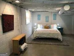 a bedroom with a bed and a mirror