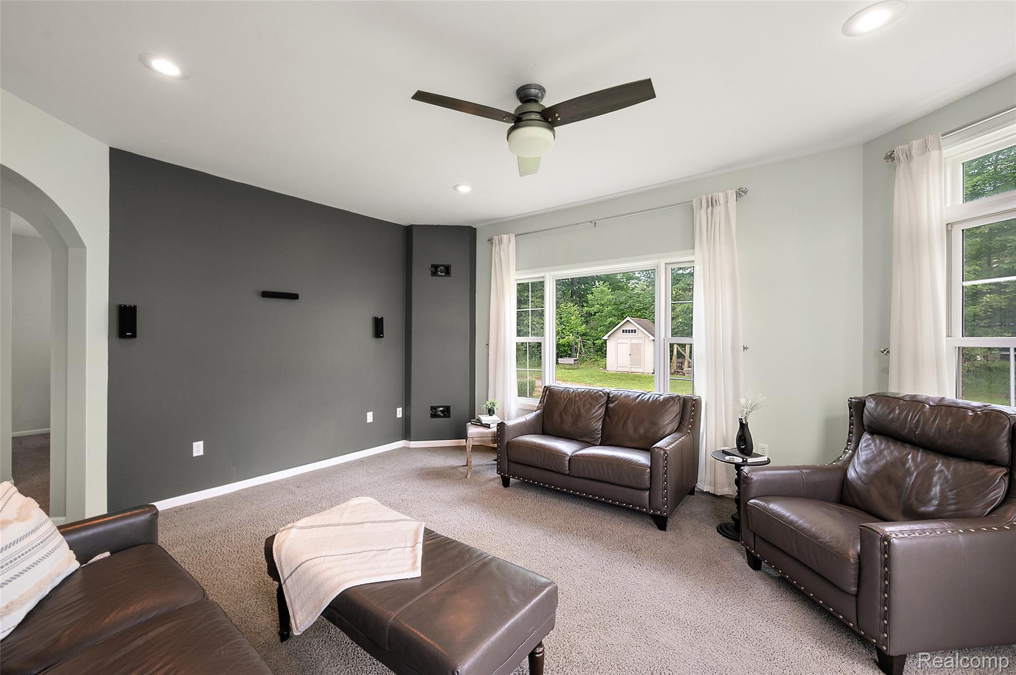 5035 Hidden Ridge Road Metamora, MI 48455 - Photo 12 of 65 Living area featuring a recessed accent wall, recessed lighting, and a ceiling fan