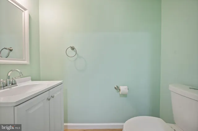 a bathroom with a sink mirror vanity and toilet