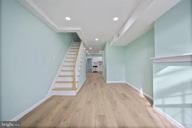 a view of entryway and hall with wooden floor