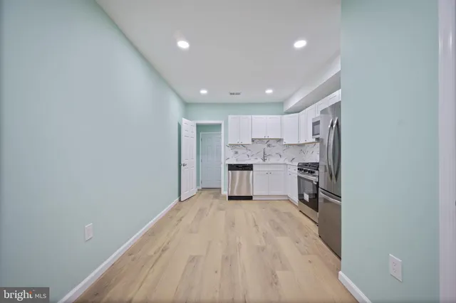 a view of a kitchen with wooden floor