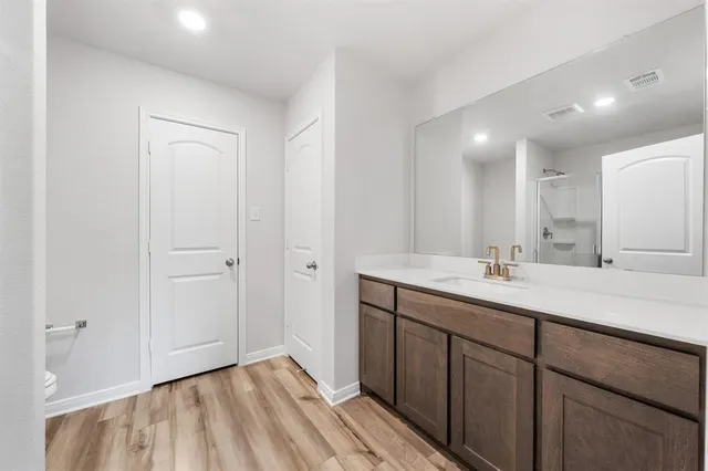 a bathroom with a double vanity sink and mirror