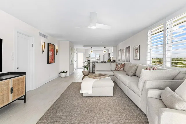 a living room with furniture white walls and a window