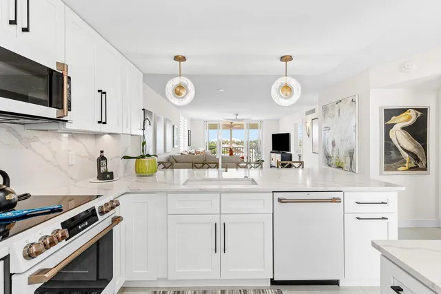 a kitchen with white cabinets and appliances