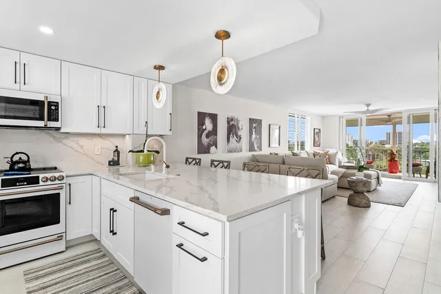 a kitchen with stainless steel appliances granite countertop a sink and cabinets