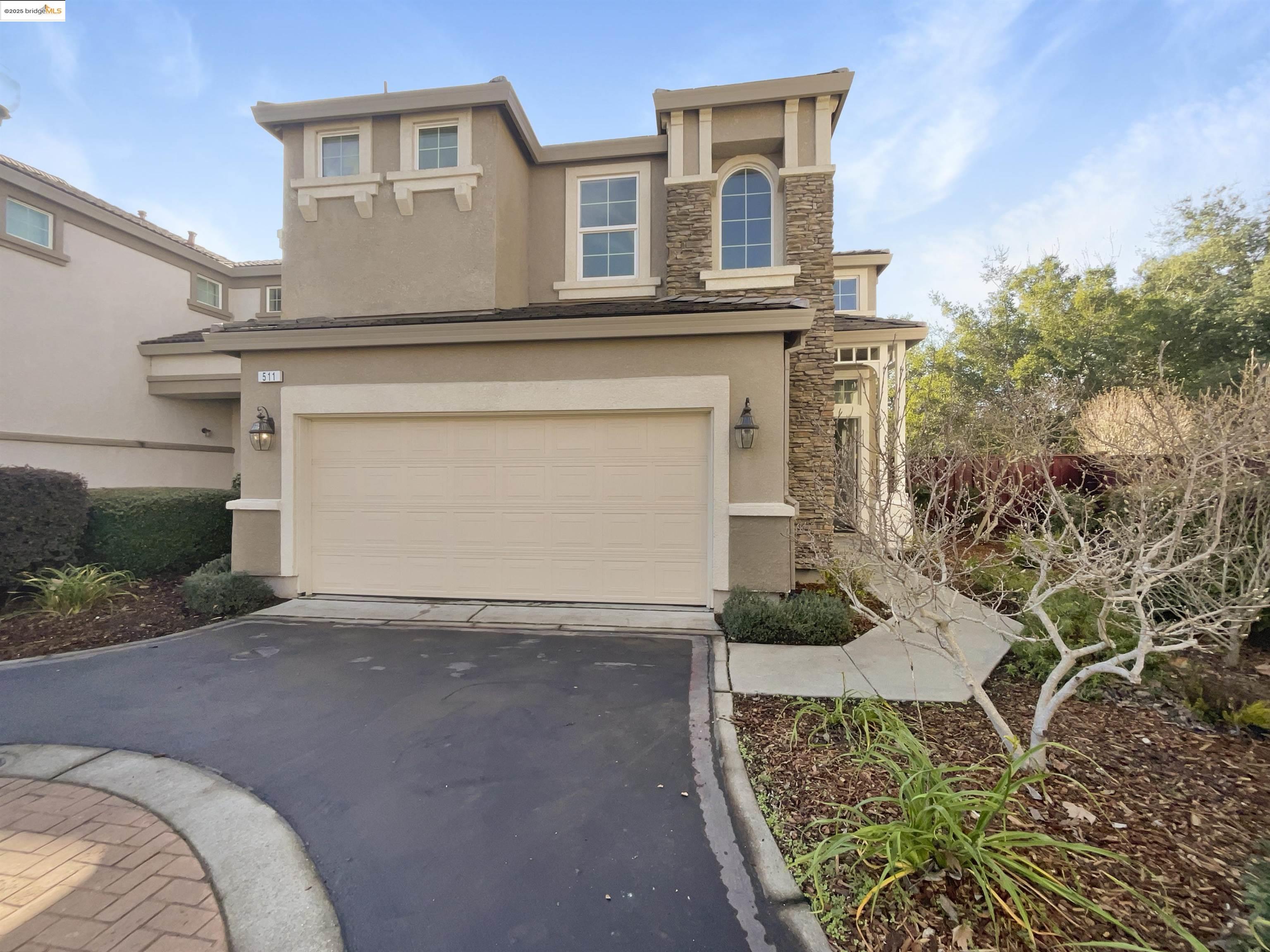 a front view of a house with a yard and garage