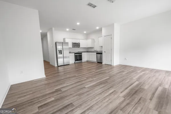 a view of kitchen with wooden floor