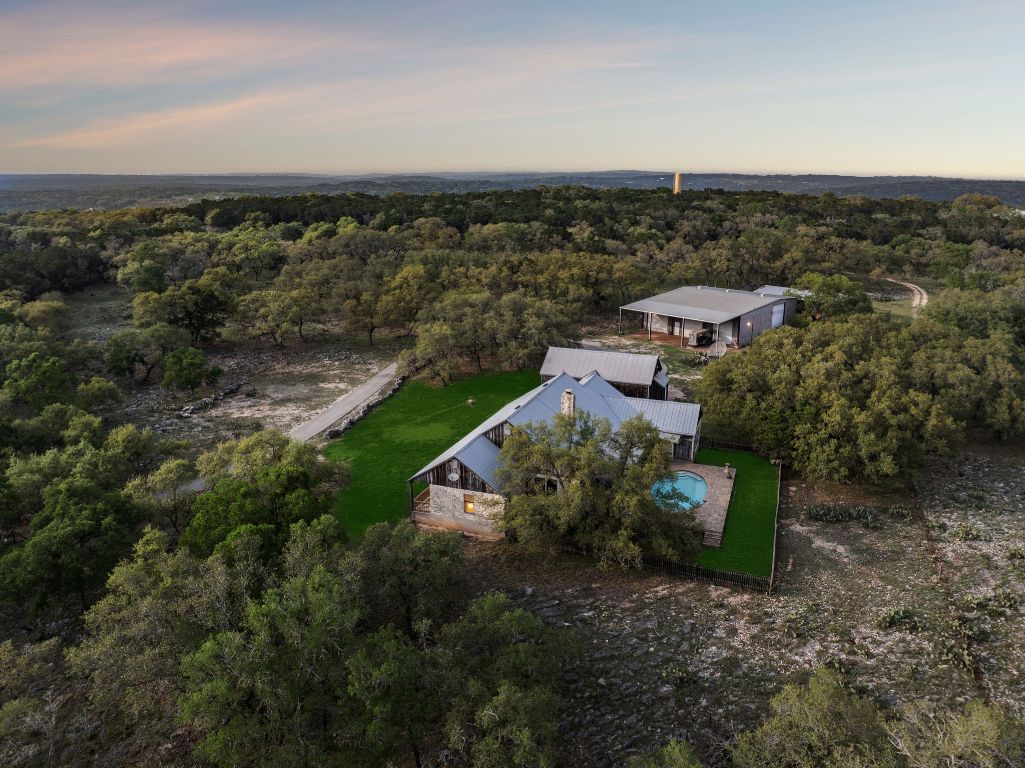 an aerial view of a house with a yard
