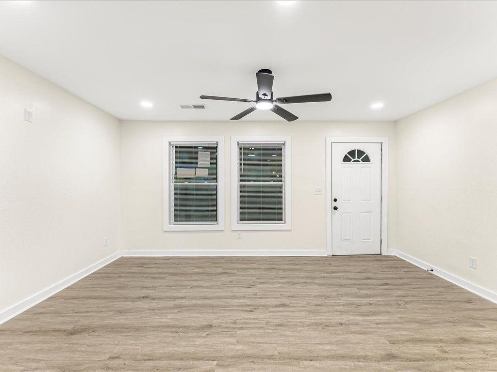 5794 Pinecrest Road Austell, GA 30168 - Photo 11 of 29 a view of an empty room with wooden floor and a window