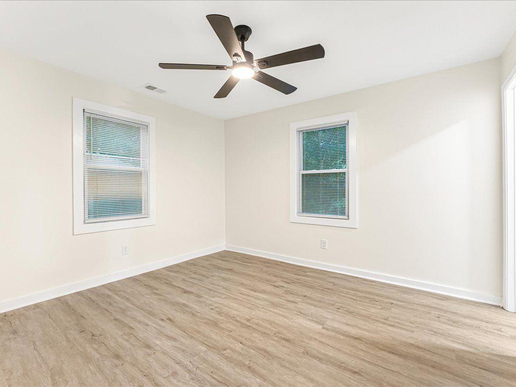 5794 Pinecrest Road Austell, GA 30168 - Photo 13 of 29 a view of an empty room with wooden floor and a window