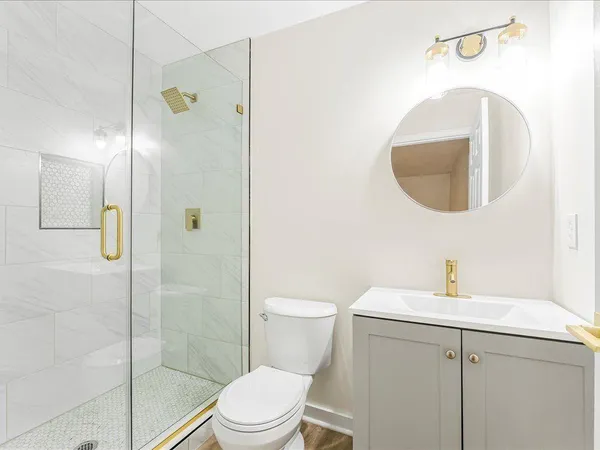 a bathroom with a toilet sink and shower
