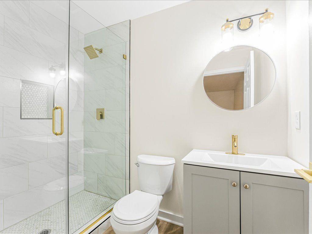5794 Pinecrest Road Austell, GA 30168 - Photo 15 of 29 a bathroom with a toilet sink and shower