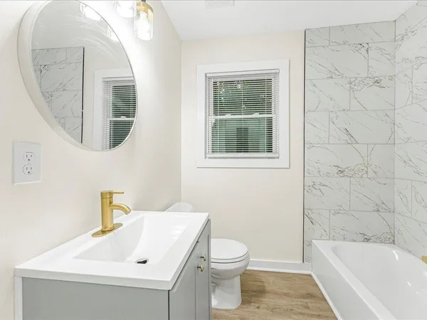 a bathroom with a sink a toilet and a bathtub