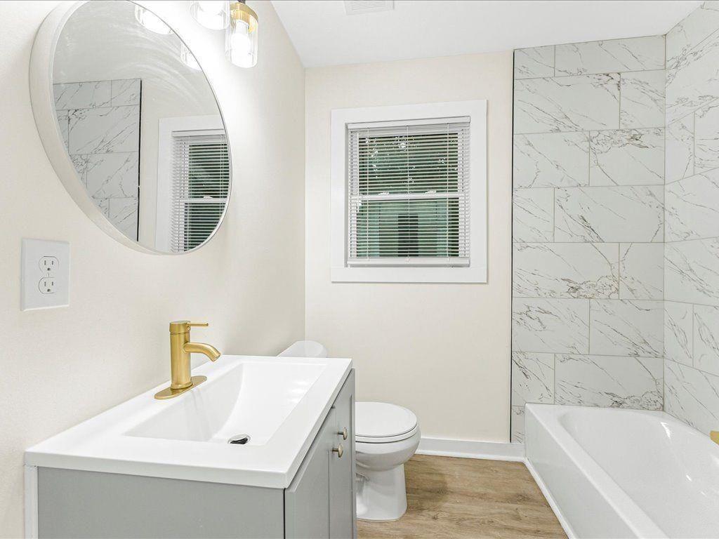 5794 Pinecrest Road Austell, GA 30168 - Photo 18 of 29 a bathroom with a sink a toilet and a bathtub