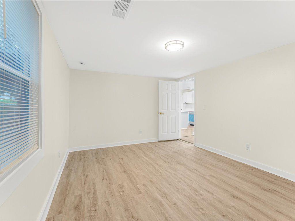 5794 Pinecrest Road Austell, GA 30168 - Photo 21 of 29 an empty room with wooden floor and windows