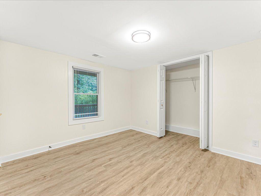 5794 Pinecrest Road Austell, GA 30168 - Photo 22 of 29 an empty room with wooden floor and window