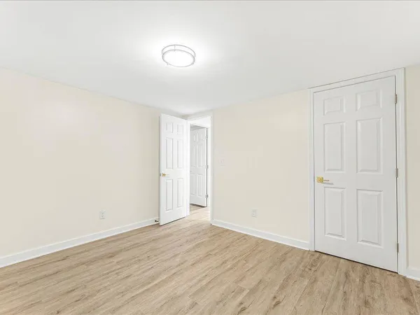 a view of an empty room and wooden floor