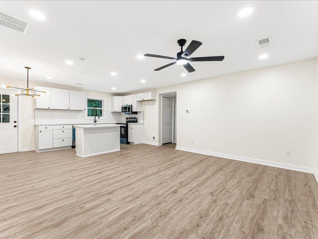 5794 Pinecrest Road Austell, GA 30168 - Photo 3 of 29 a view of a kitchen with wooden floor and stainless steel appliances