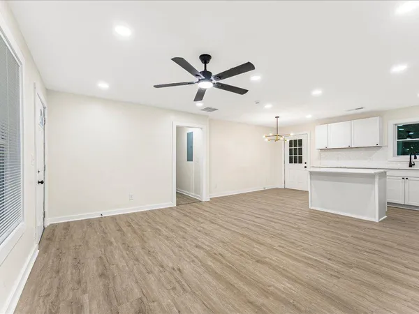 a view of a kitchen with a sink and a refrigerator