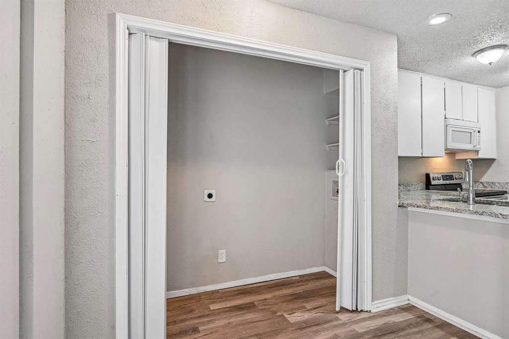 5534 Boca Raton Boulevard, Unit 292 Fort Worth, TX 76112 - Photo 12 of 31 a view of a kitchen with wooden floor
