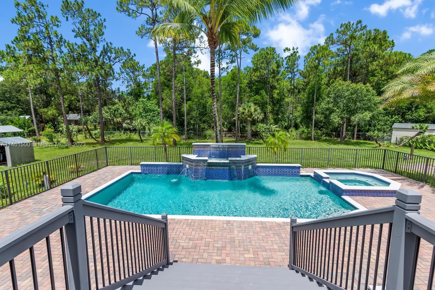 16189 Alexander Run Jupiter, FL 33478 - Photo 12 of 78 a view of backyard with swimming pool and green space