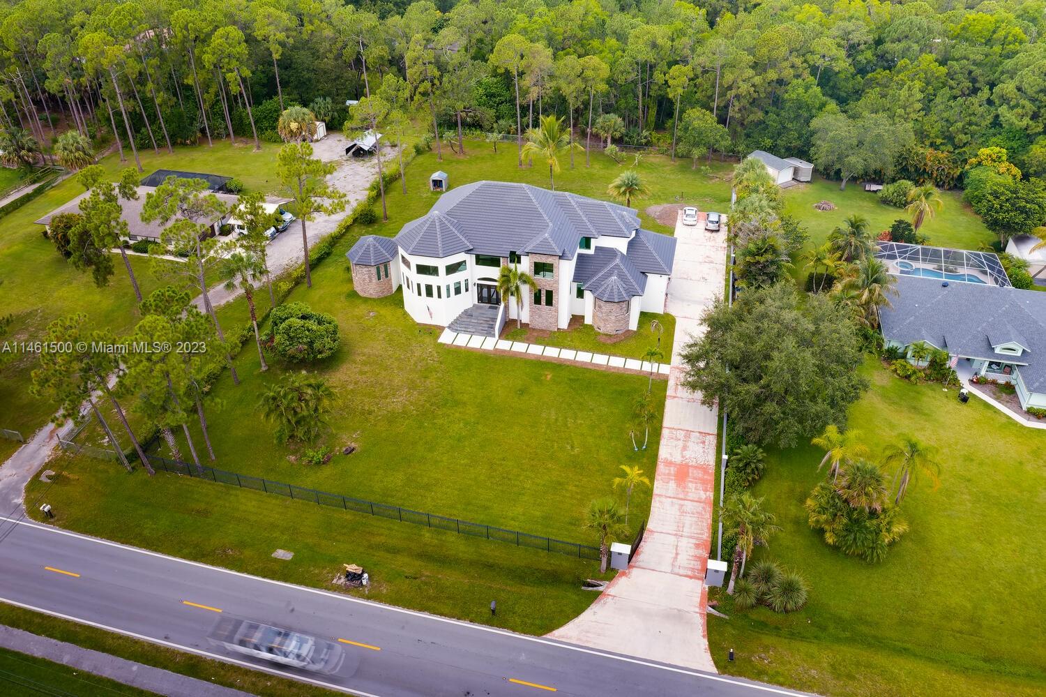 16189 Alexander Run Jupiter, FL 33478 - Photo 17 of 78 an aerial view of a residential houses with outdoor space and a lake view