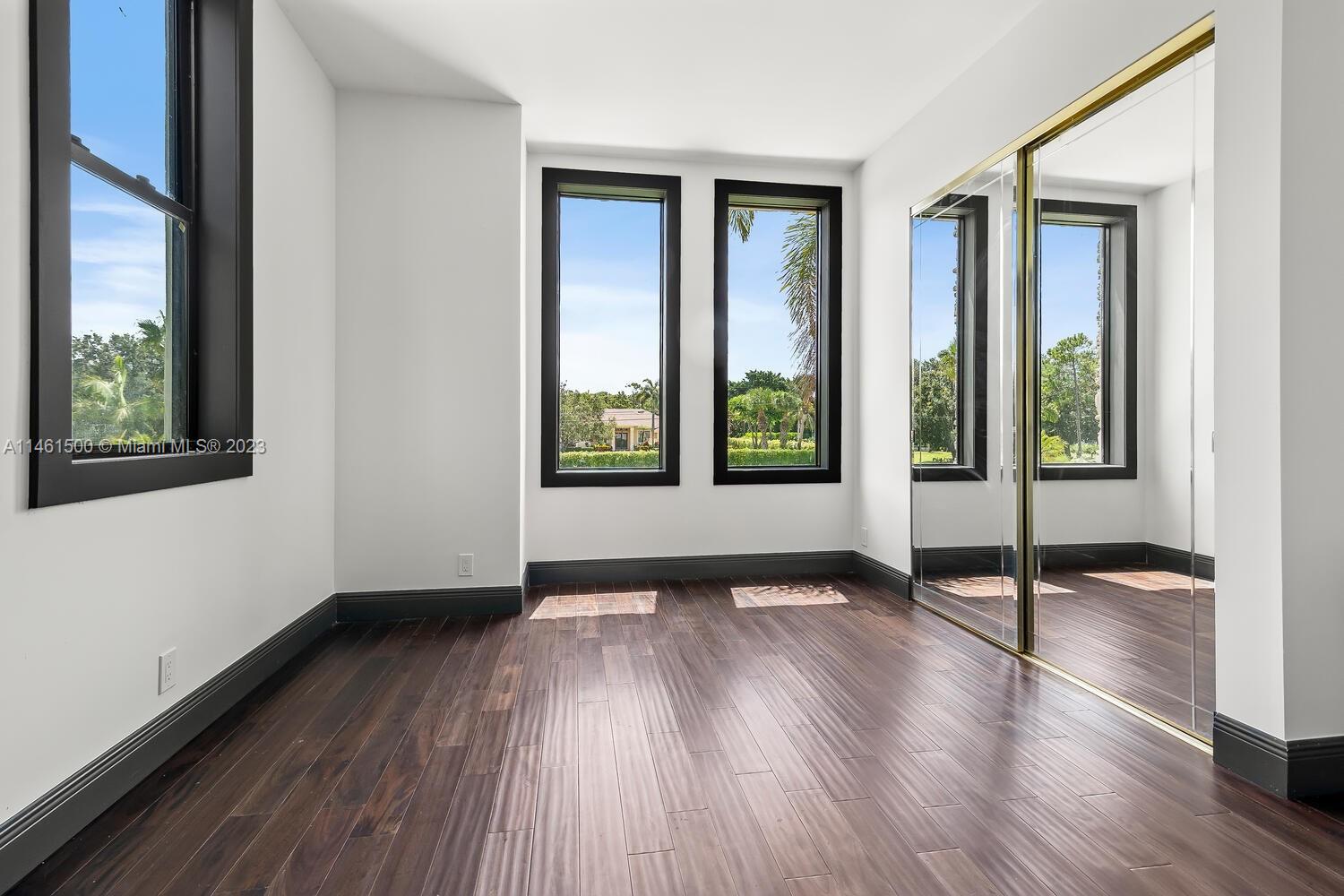 16189 Alexander Run Jupiter, FL 33478 - Photo 26 of 78 a view of an empty room with wooden floor and a window