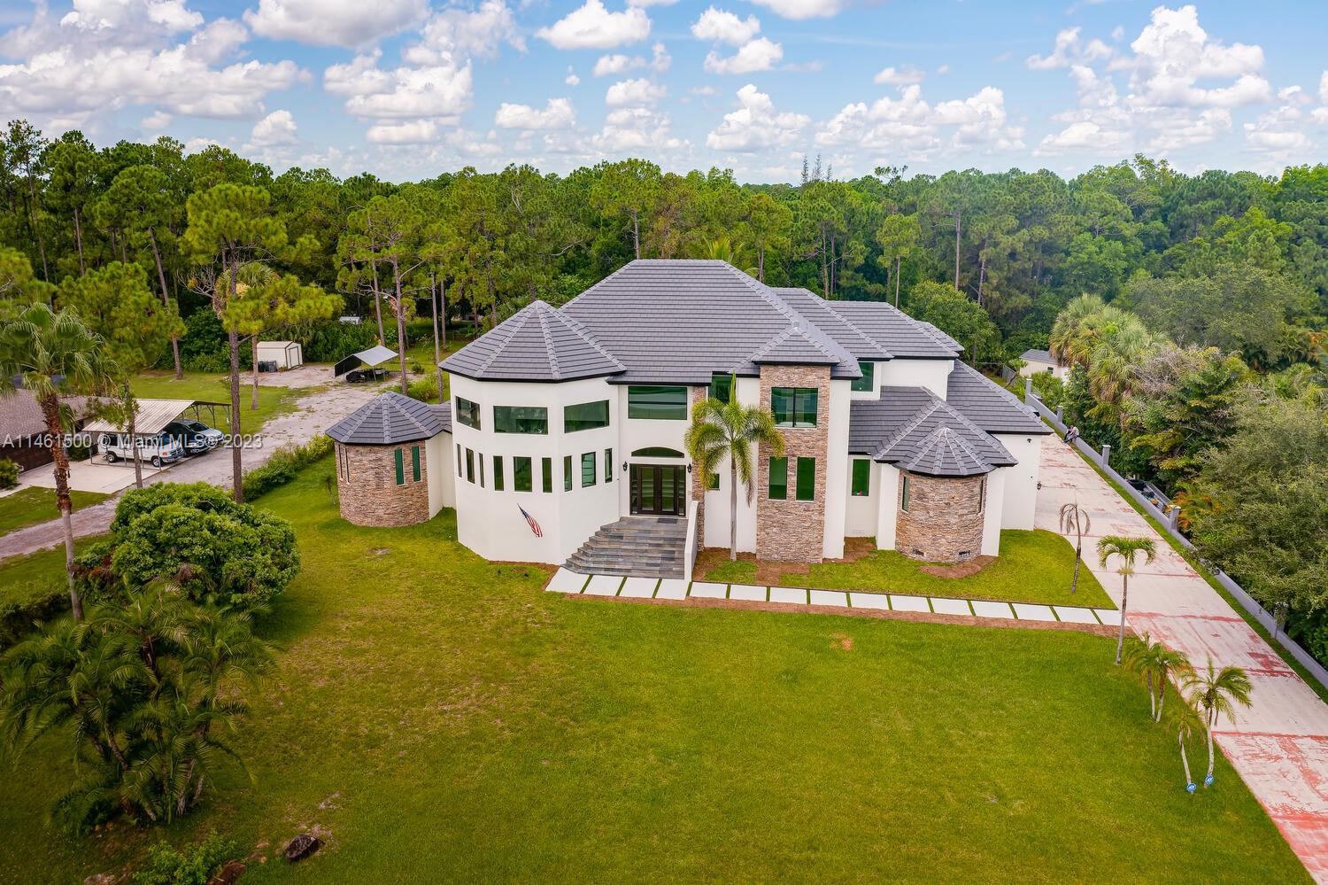 16189 Alexander Run Jupiter, FL 33478 - Photo 3 of 78 a view of a house with a big yard