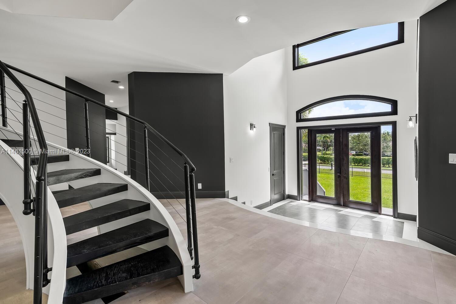 16189 Alexander Run Jupiter, FL 33478 - Photo 31 of 78 a view of entryway and hall with wooden floor