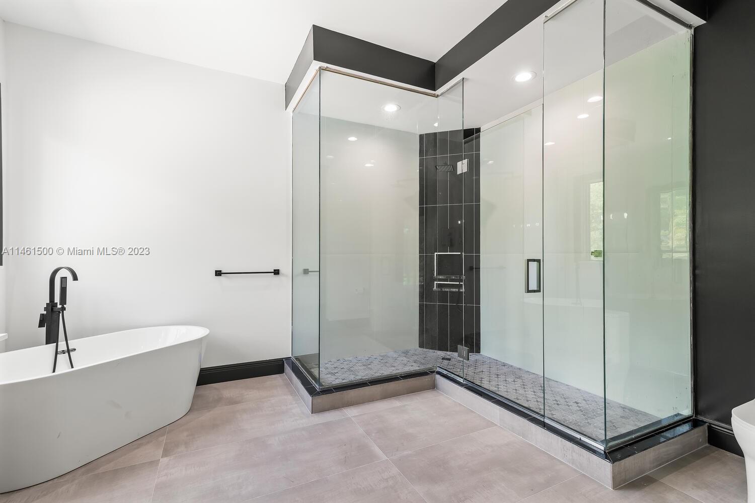 16189 Alexander Run Jupiter, FL 33478 - Photo 35 of 78 a bathroom with a bathtub and a shower