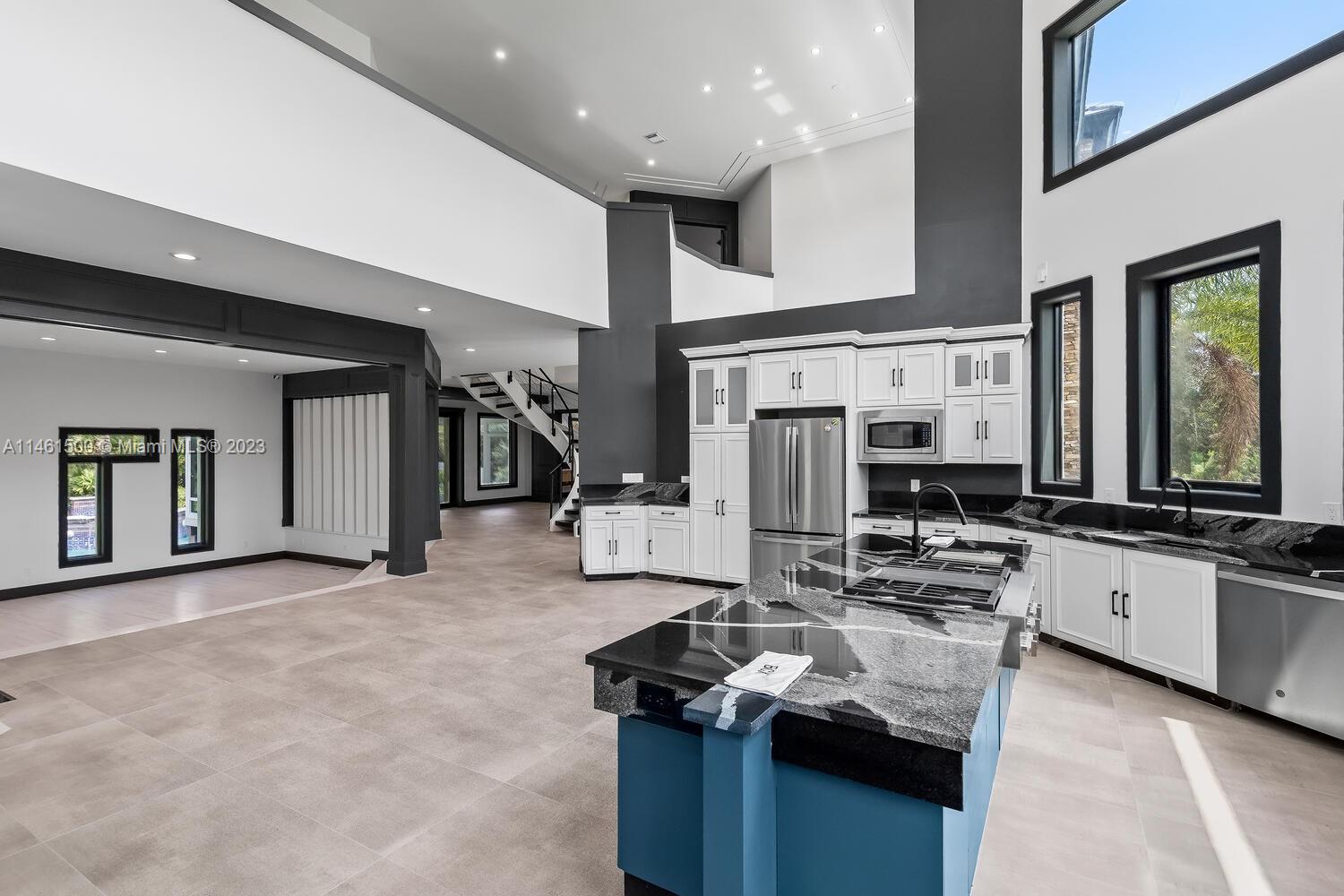 16189 Alexander Run Jupiter, FL 33478 - Photo 40 of 78 a kitchen with stainless steel appliances granite countertop a stove and a sink