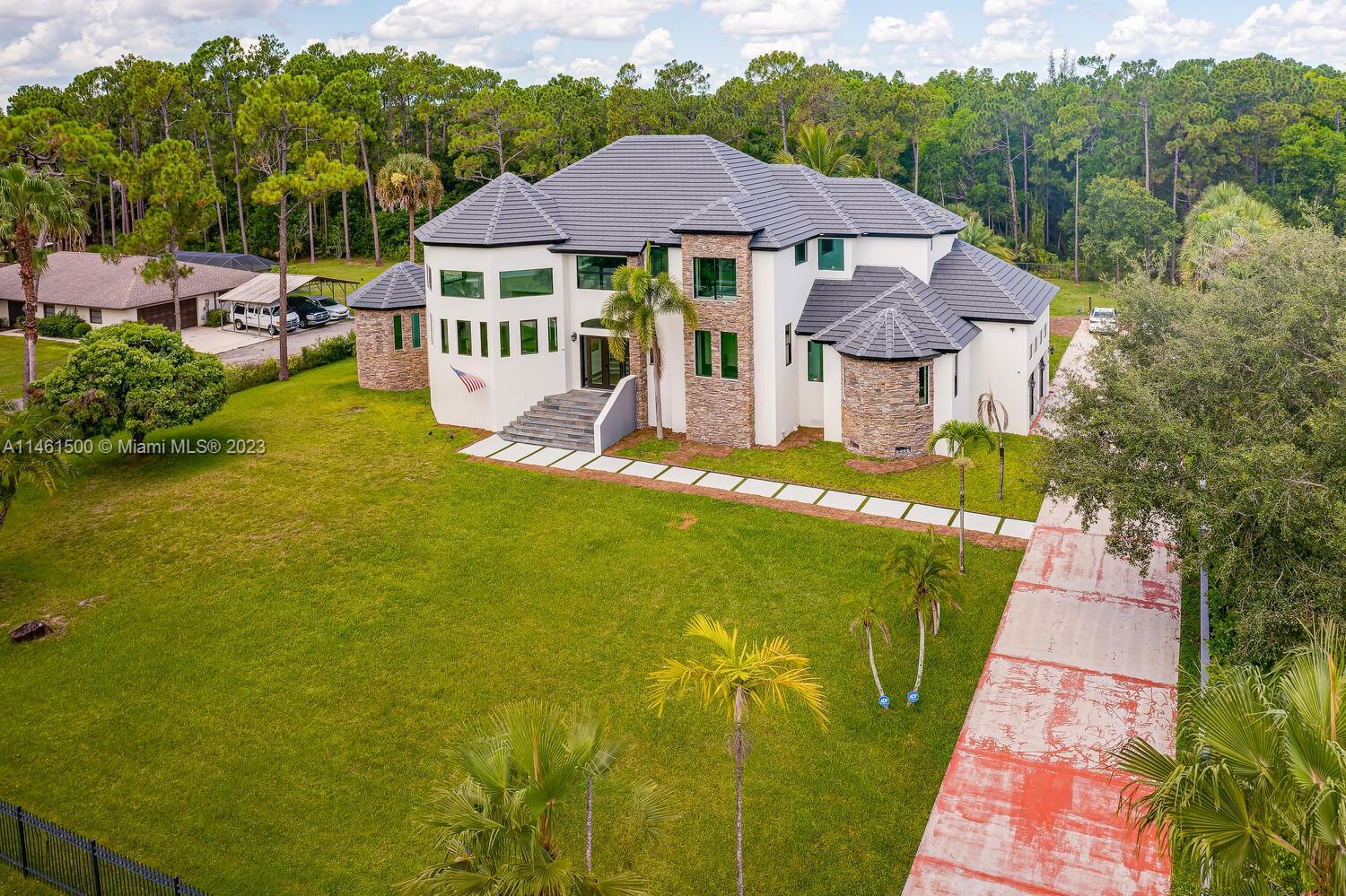 16189 Alexander Run Jupiter, FL 33478 - Photo 4 of 78 a view of a house with a yard