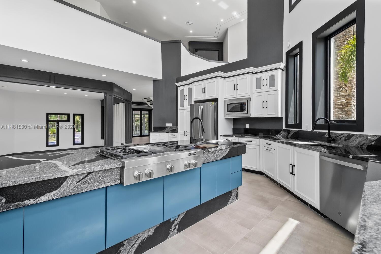 16189 Alexander Run Jupiter, FL 33478 - Photo 42 of 78 a large kitchen with stainless steel appliances granite countertop a sink and cabinets