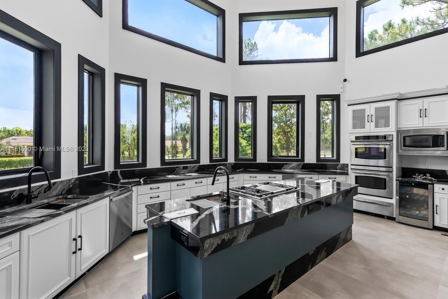 16189 Alexander Run Jupiter, FL 33478 - Photo 46 of 78 a view of a kitchen counter top space with stainless steel appliances granite countertop a sink and a stove