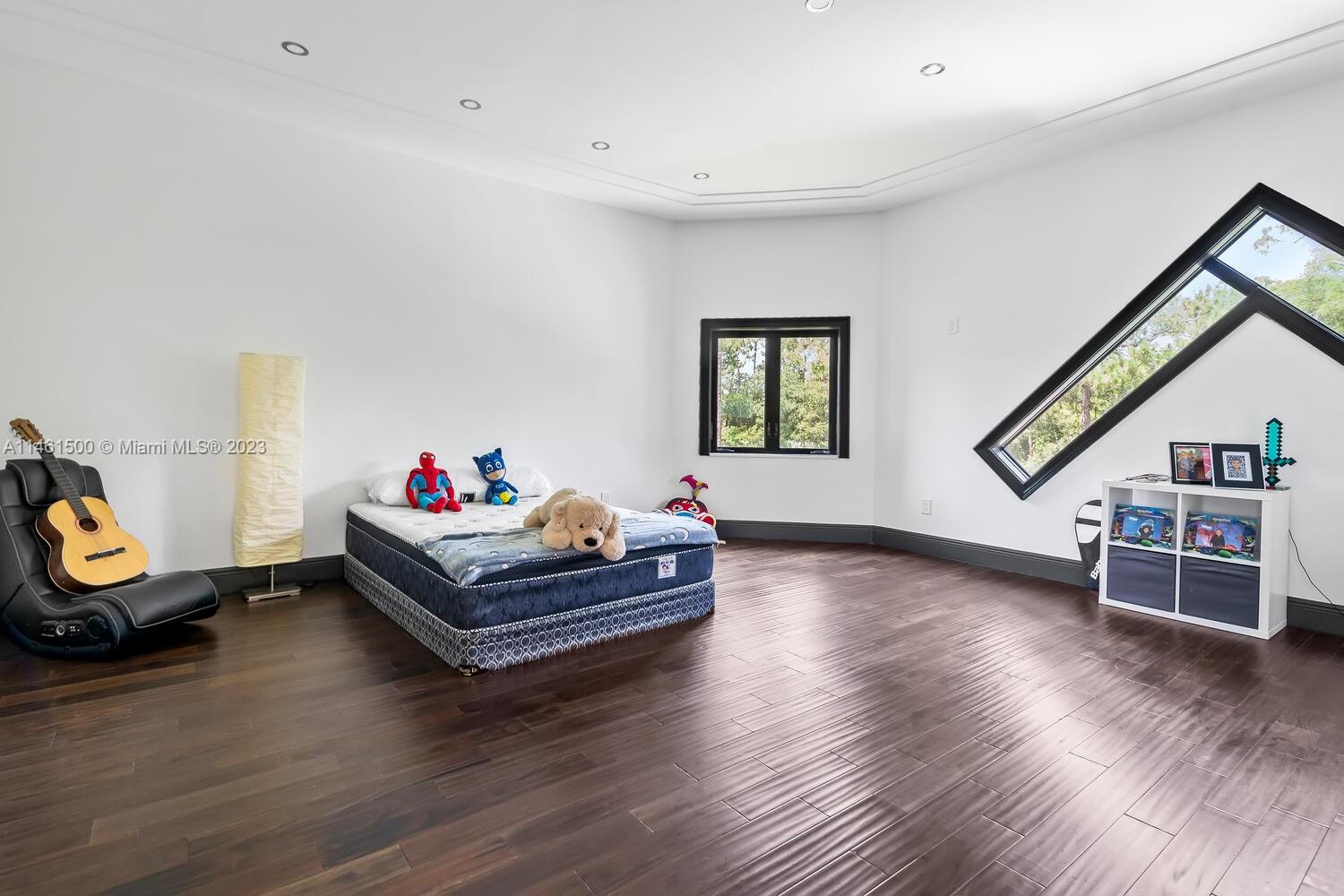 16189 Alexander Run Jupiter, FL 33478 - Photo 52 of 78 a living room with furniture and a wooden floor