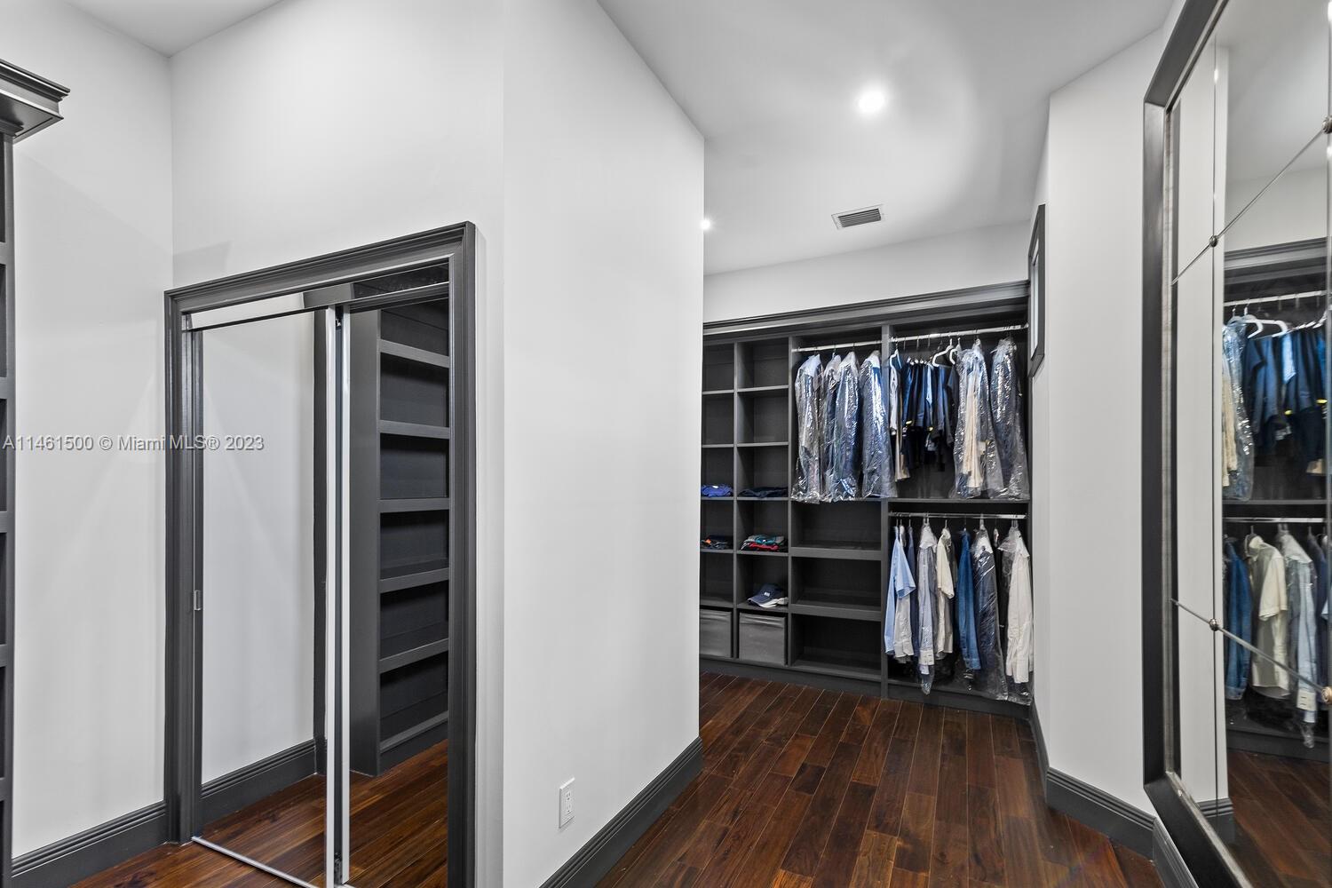 16189 Alexander Run Jupiter, FL 33478 - Photo 58 of 78 a view of walk in closet with clothes and shoes