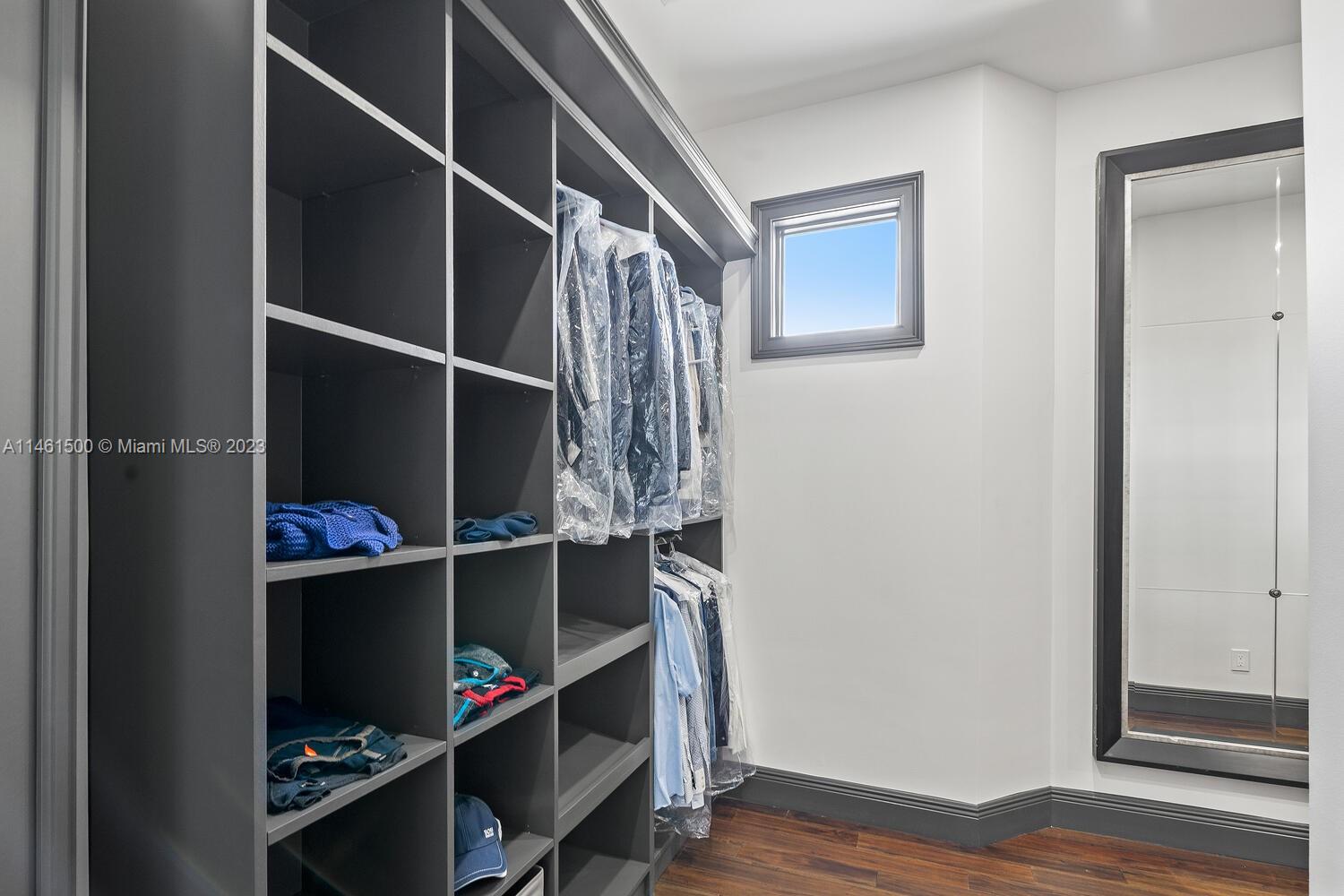 16189 Alexander Run Jupiter, FL 33478 - Photo 59 of 78 a view of walk in closet with clothes and shoes
